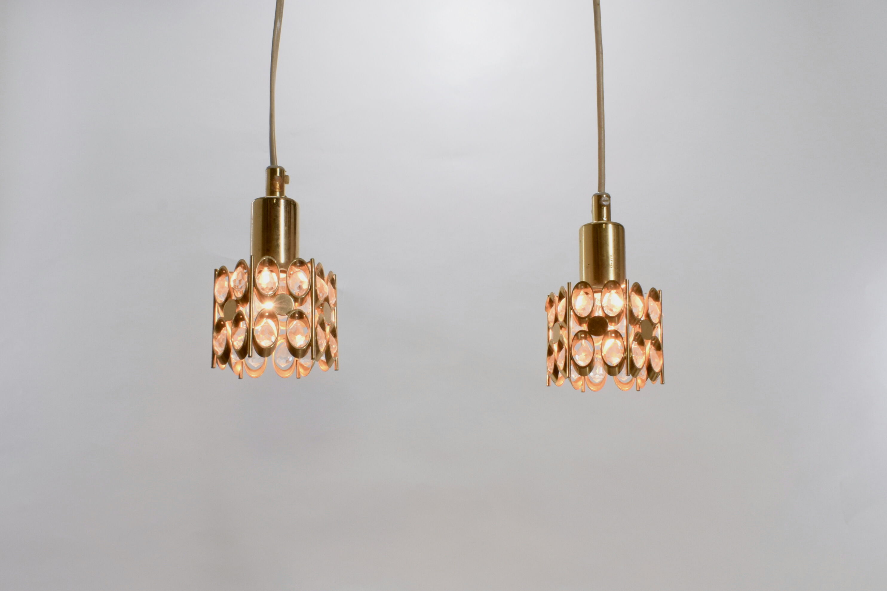 Two pendant lights in gilded brass and crystal, by Palwa, design 1960