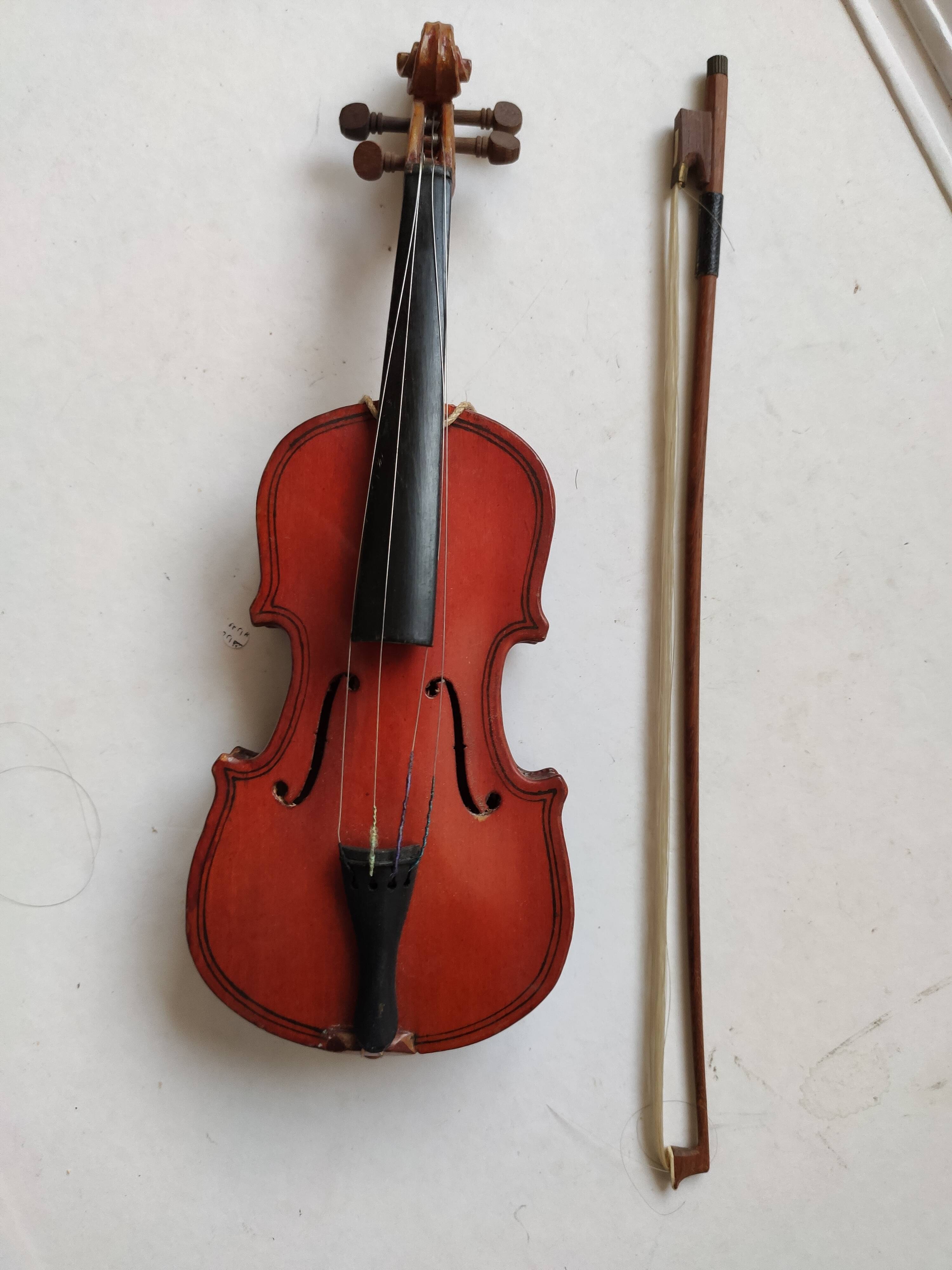 violin and decorative archer in antique varnished wood
