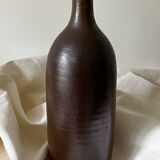Old bottle in matte brown stoneware