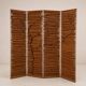 Wooden screen with slats, black plant decoration.