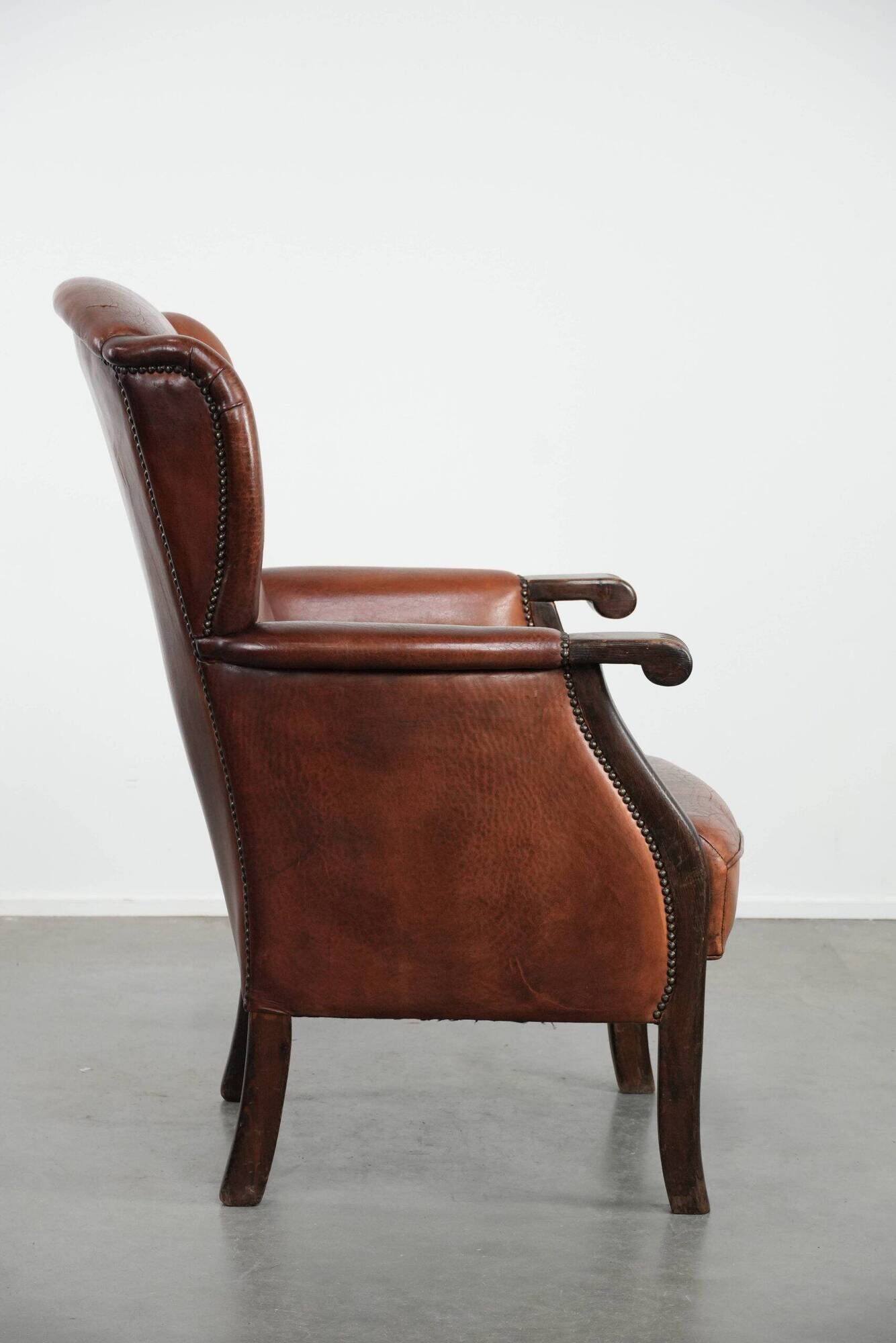 Classic vintage wingback chair in sheepskin and wood