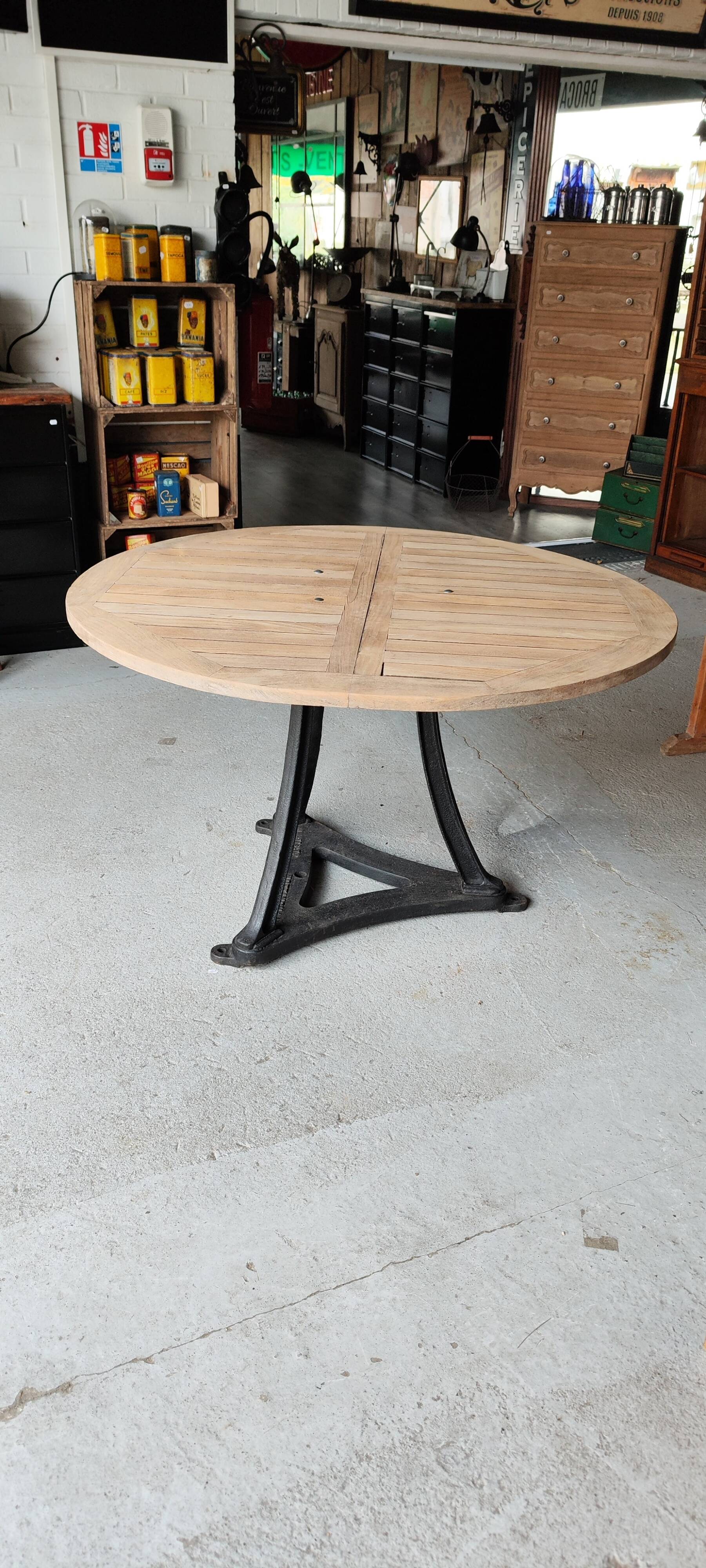 Industrial table with cast iron legs and teak top