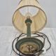Brass table lamp with green patina and empire-style fabric shade.
