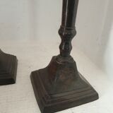 Two pairs of patinated brass candle holders