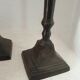 Two pairs of patinated brass candle holders