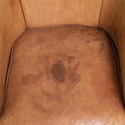 Comfortable sheepskin club armchair in a cognac colour