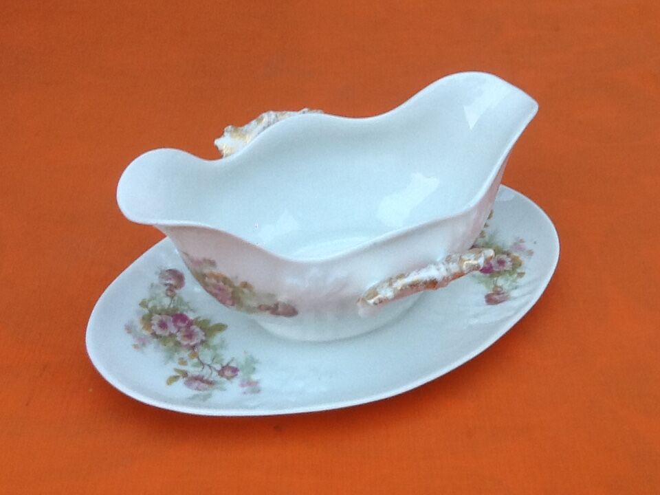 Sauce boat on dormant white porcelain, floral decoration