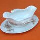 Sauce boat on dormant white porcelain, floral decoration