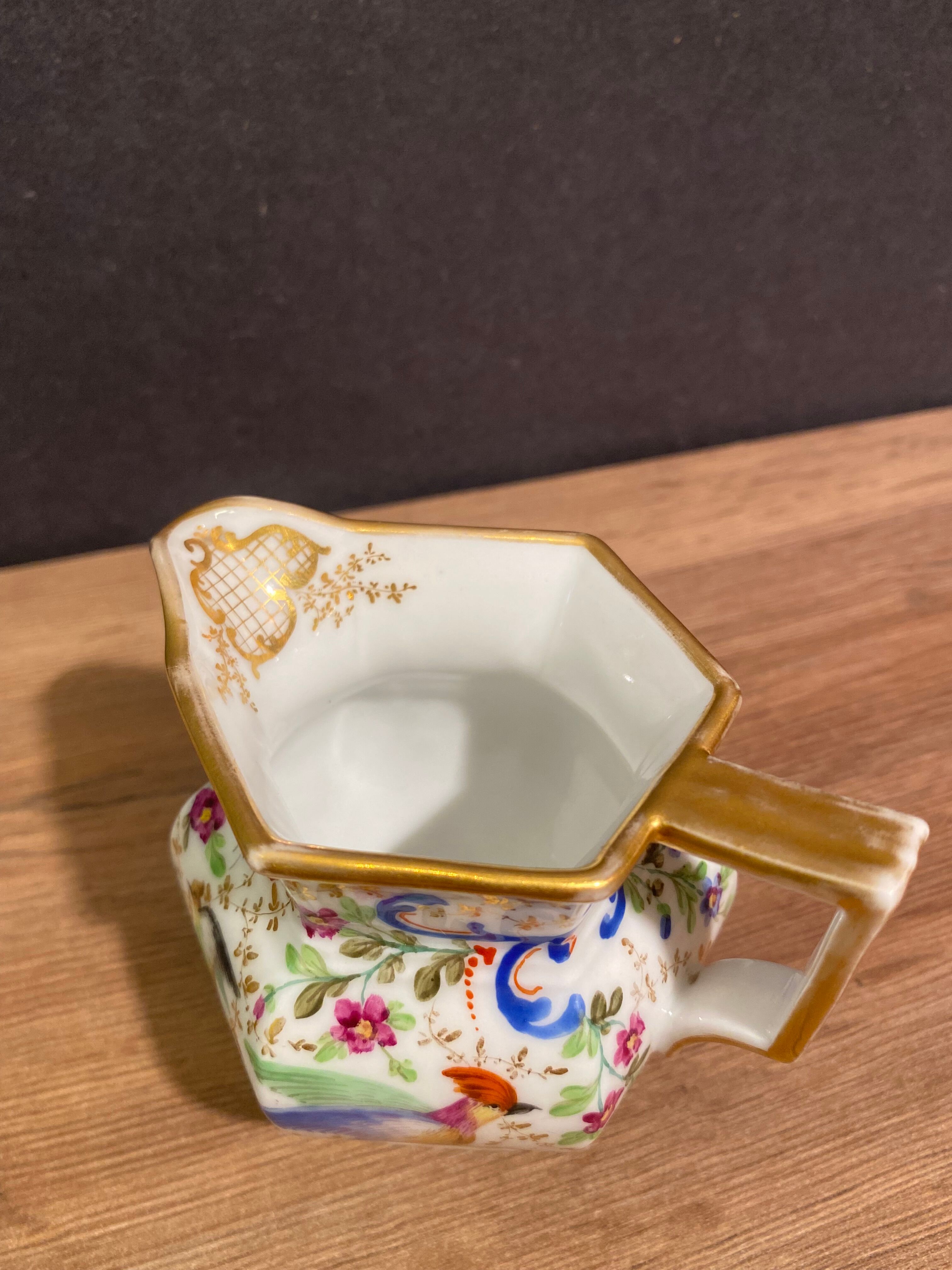 Old Paris porcelain milk jug with polychrome and gold bird floral decoration