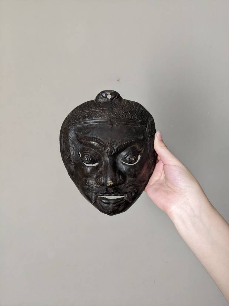 Ancient Indonesian bronze mask antique ethnic decoration tribal theater