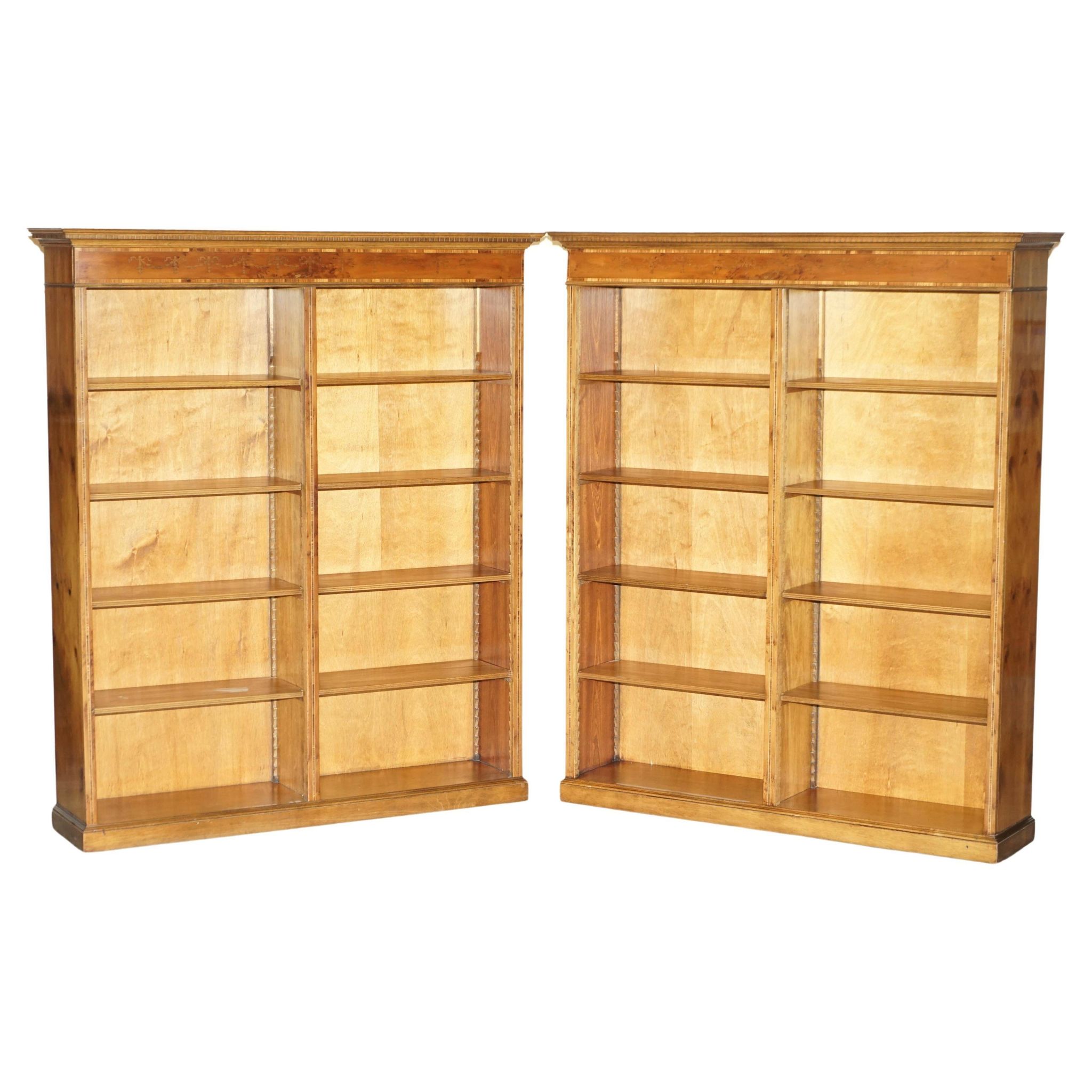 Pair of Sheraton Revival bookcases in satinwood, walnut, and yew.