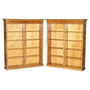 Pair of Sheraton Revival bookcases in satinwood, walnut, and yew.