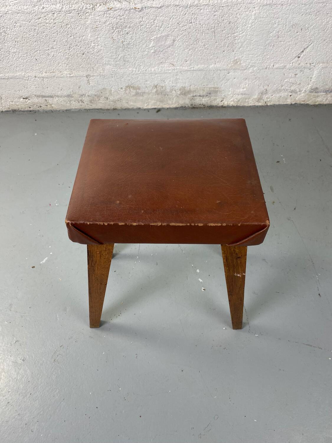 Small stool or footrest in wood and leather