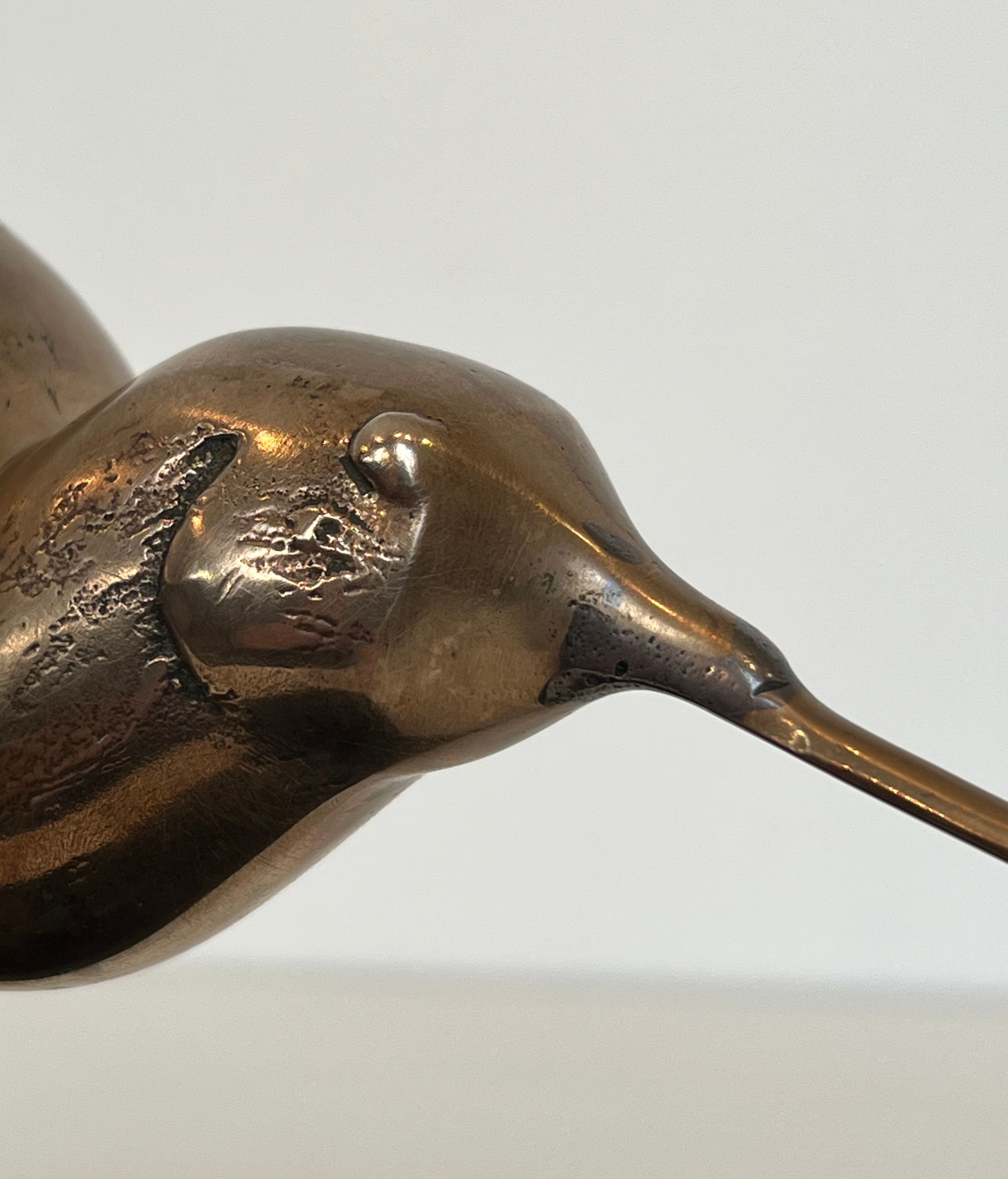 Bronze sculpture representing a stylised bird on a black marble base, signed and numbered.