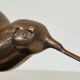 Bronze sculpture representing a stylised bird on a black marble base, signed and numbered.