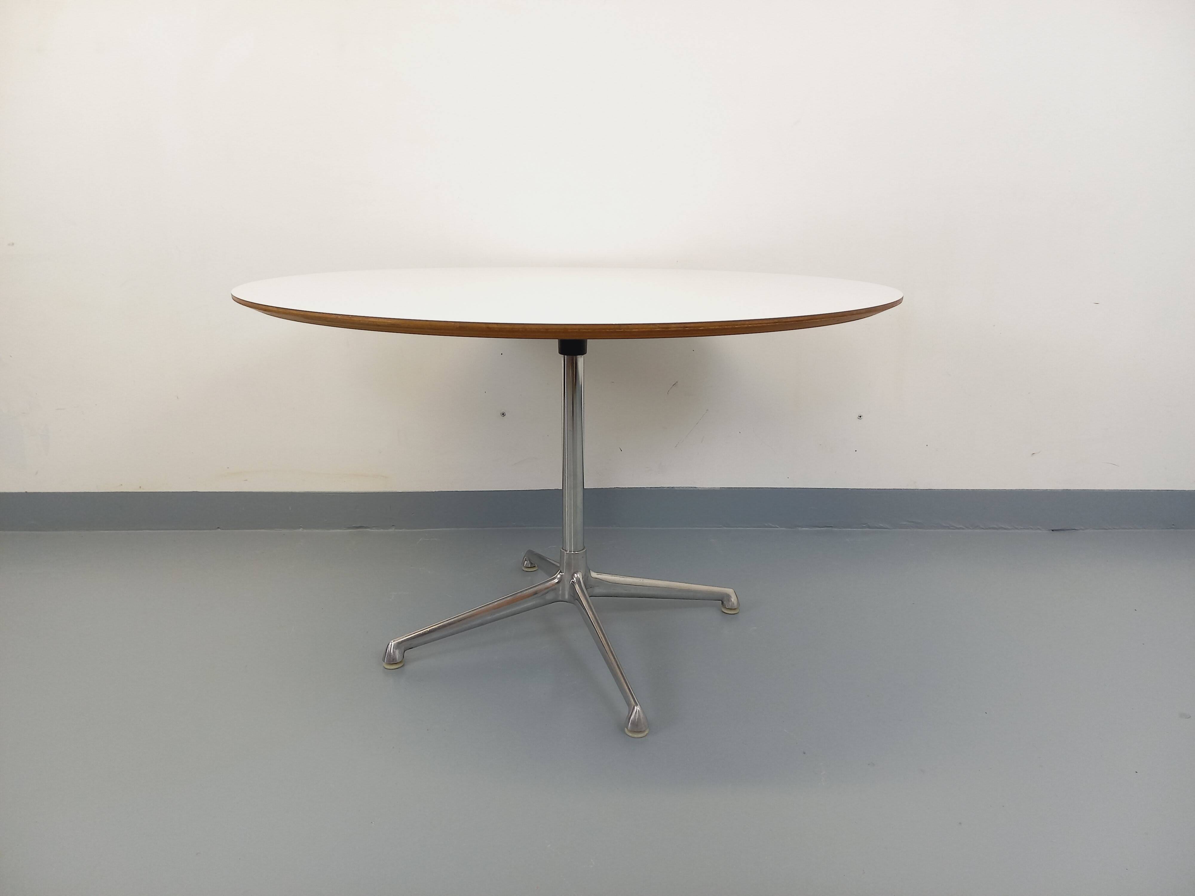 Vintage Eames round table for Vitra in white melamine, wood, and metal.
