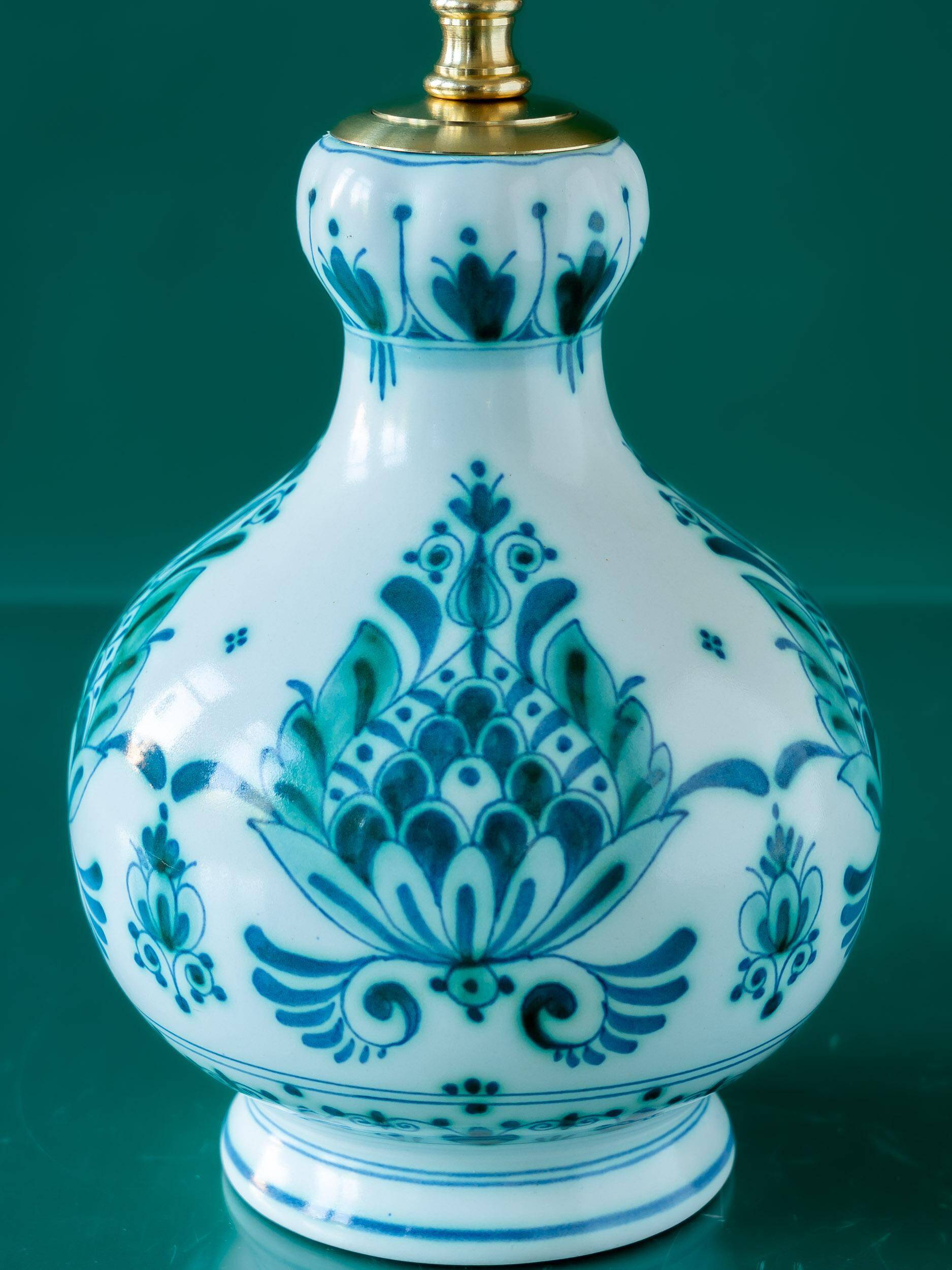 Royal Delft blue-green ceramic table lamp with pink jacquard peacock shade.