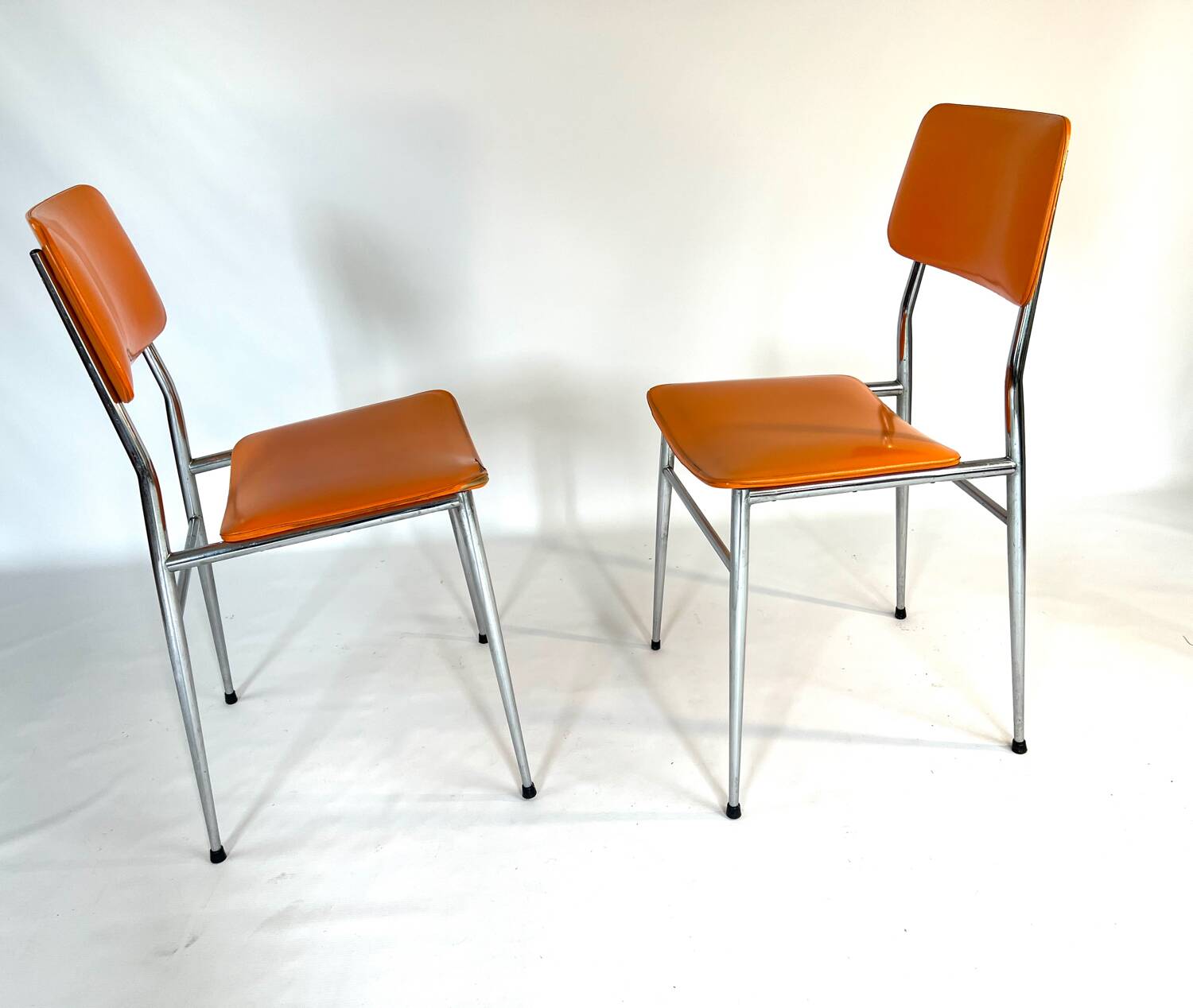 Pair of vintage orange leatherette chairs