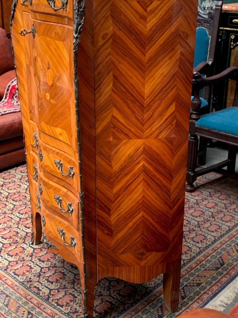 Old French secretary in bronze and wood marquetry.