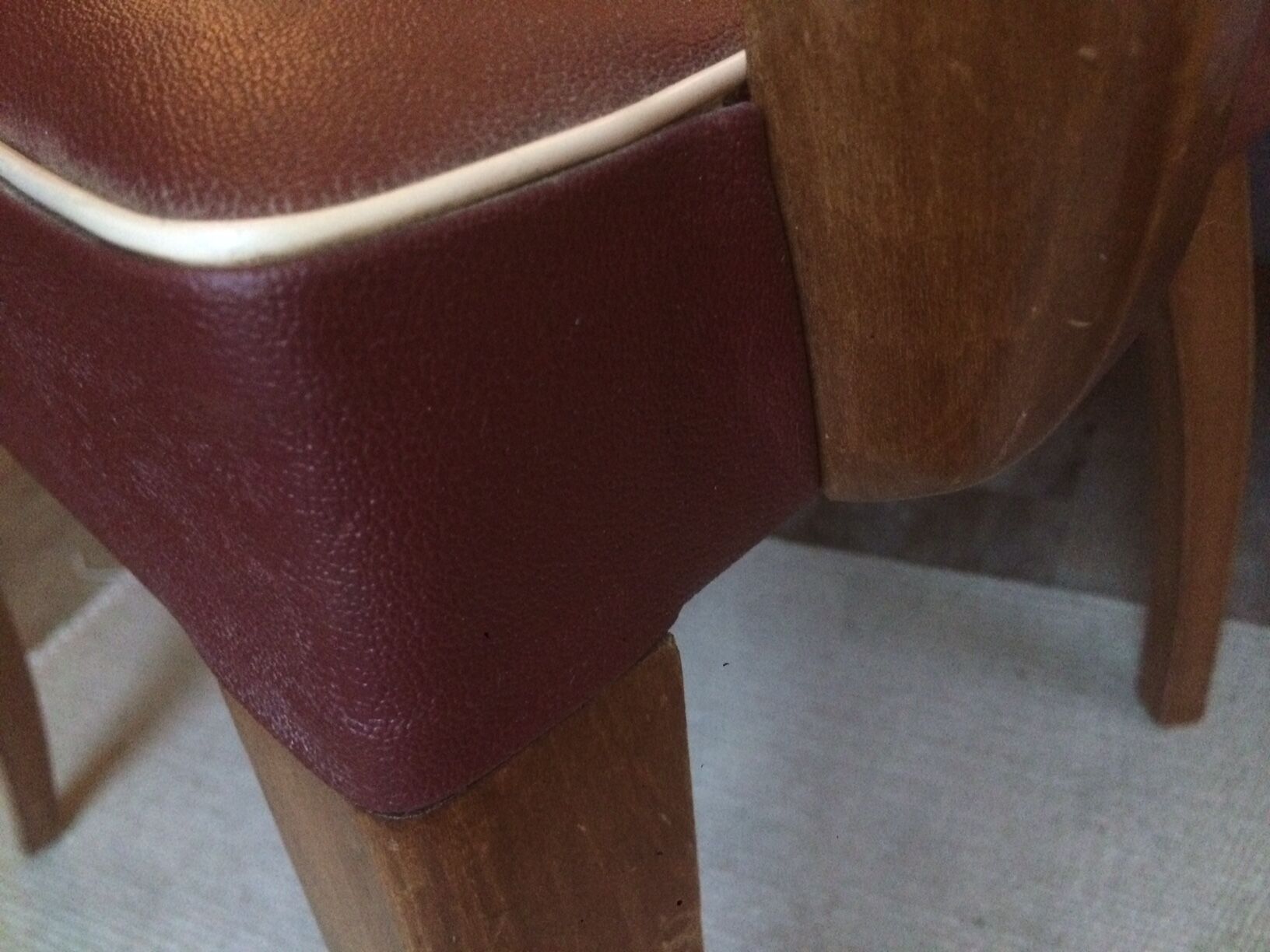 Skai chair binds wine and wooden footpieces and armrests