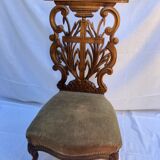 Low armchair in carved wood