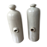 Lot of two old bottles of beige enamelled sandstone bottles