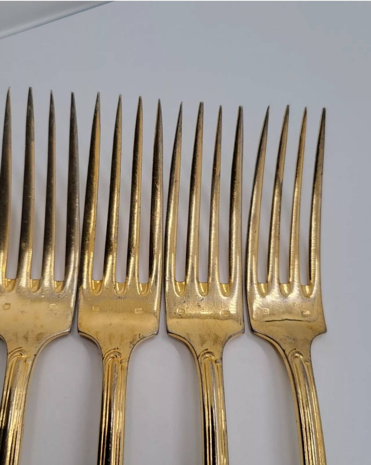 12 Table Forks in gold metal