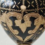 Vintage brass vase with black and gold patina, corolla neck. From India. Mid-20th century. Engraved heart/floral/leafy patterns. High 20 cm