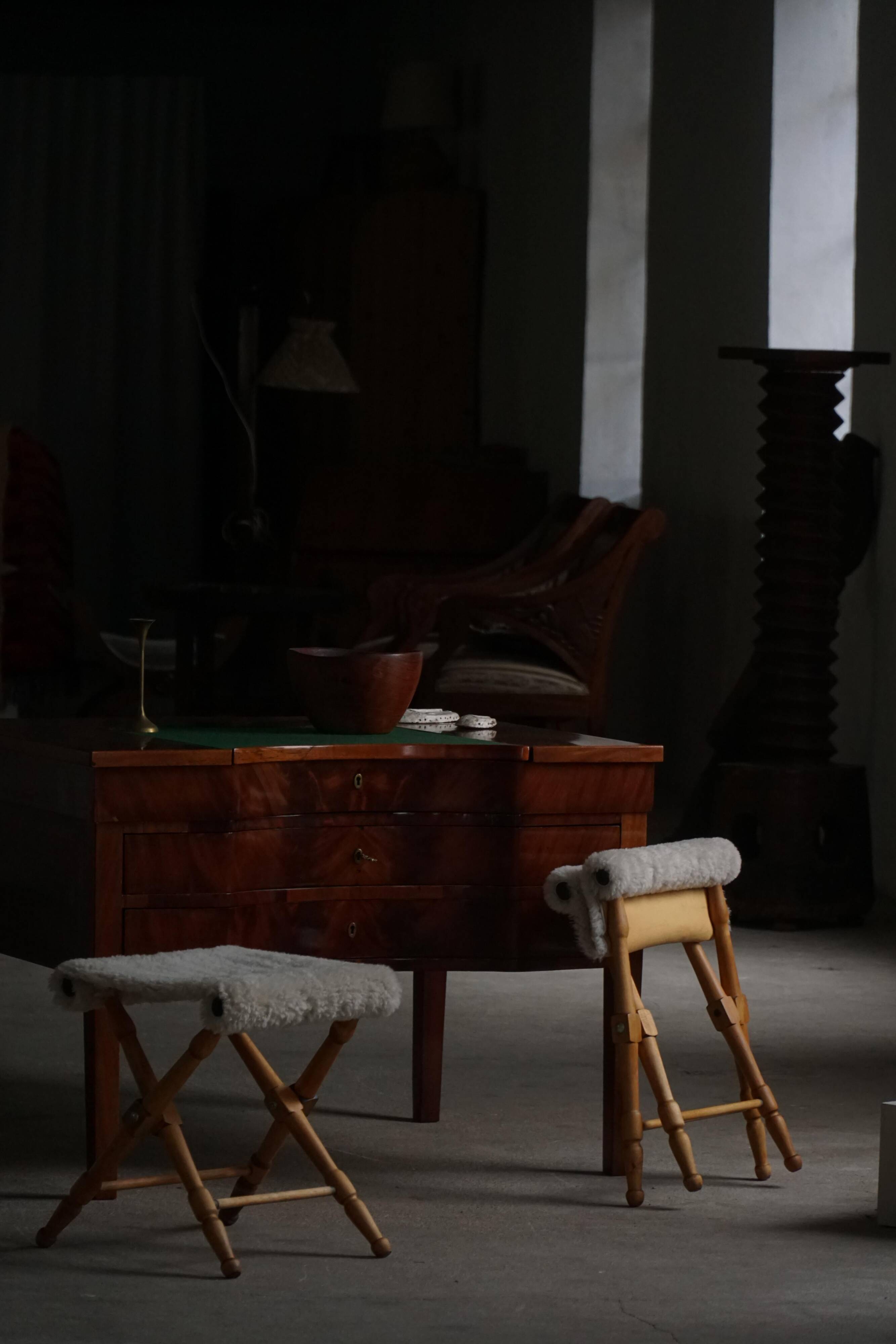 Pair of Danish mid-century folding stools with sheepskin upholstery, 1960.