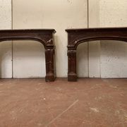 Pair of Louis XIV style fireplaces in red cherry marble. XIX century.