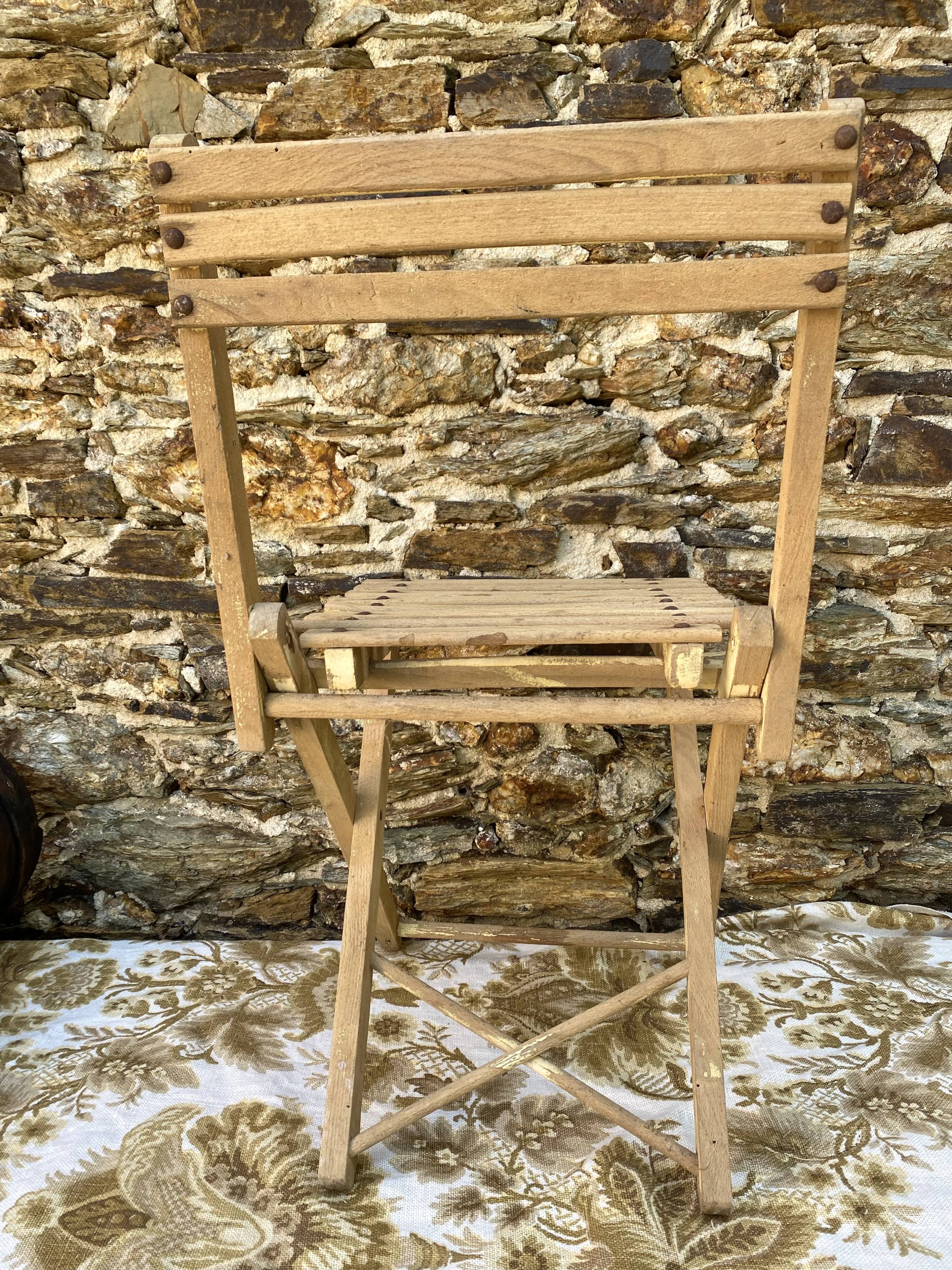 Antique folding chair with wooden slats
