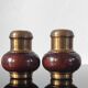 Vintage salt and pepper shaker duo in brass and turned wood.