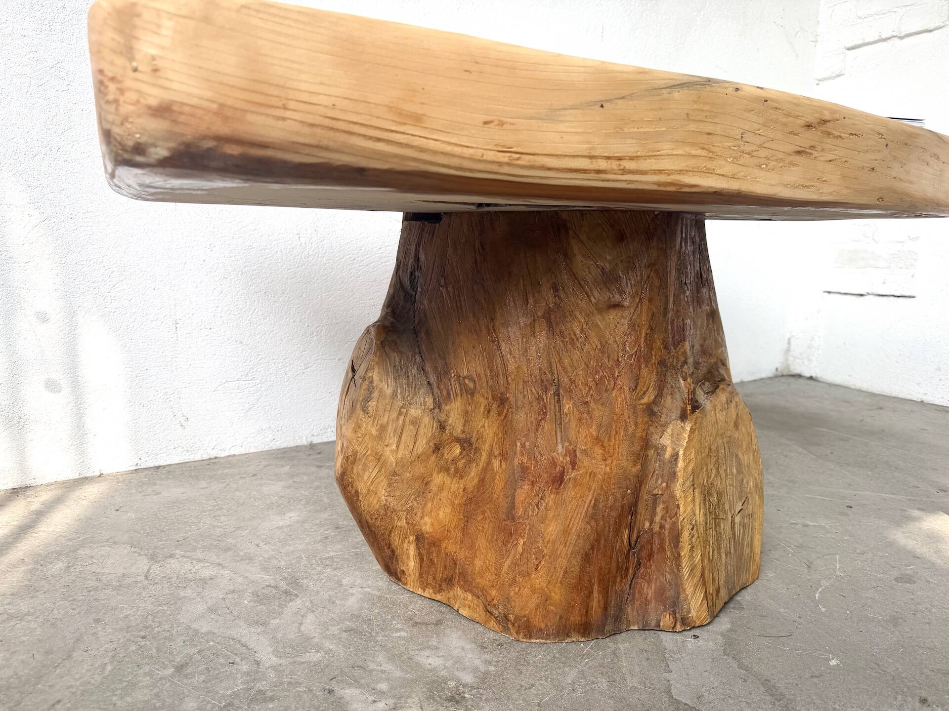 Organic brutalist coffee table in solid cedar, trunk pedestal, 1970s.