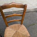 2 solid oak carved and rush-seated chairs in the Louis Philippe style, 19th century.