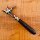 Napoleon III leg of lamb fork from the 19th century with a silver-plated handle and an ebony handle.