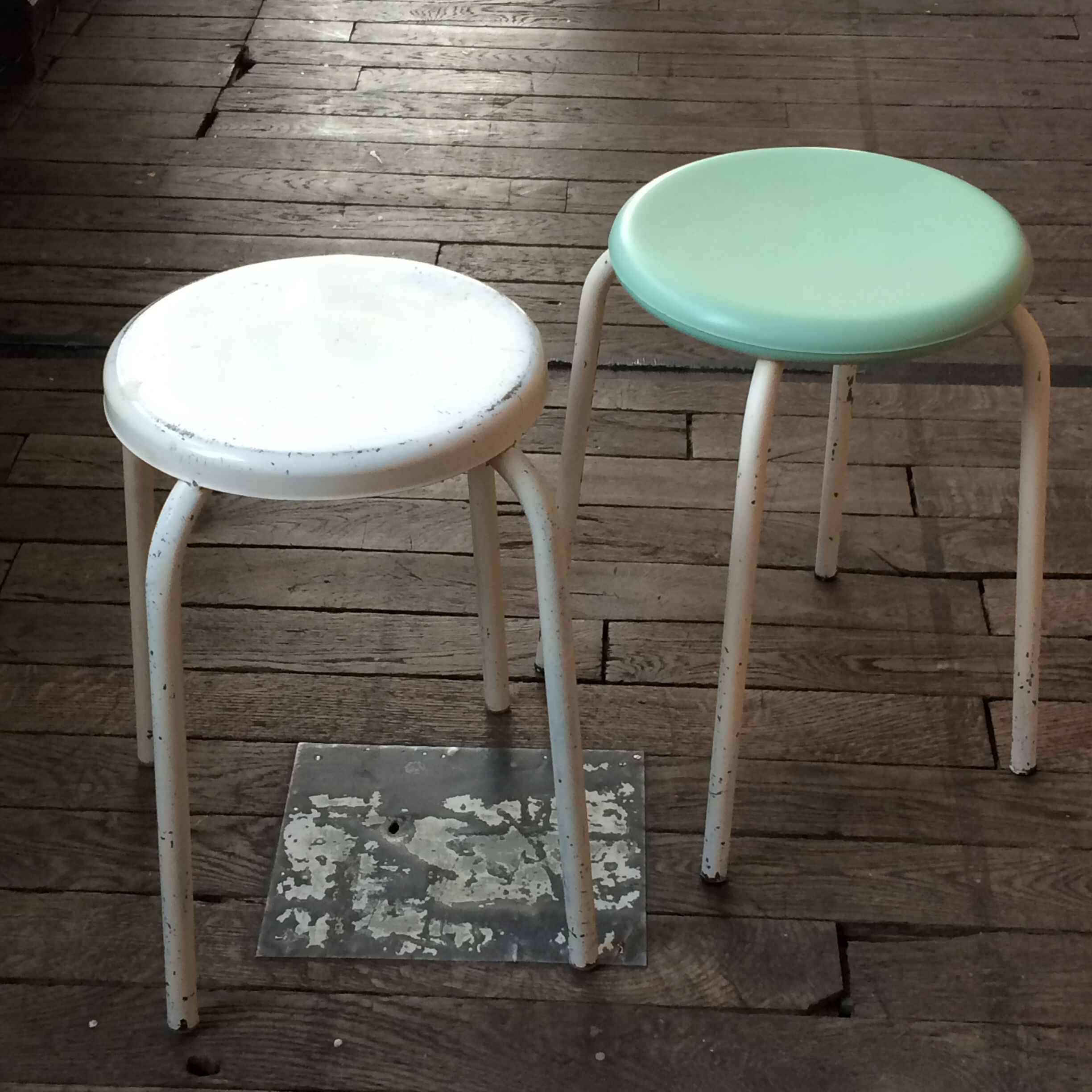 Two white and mint green stools