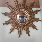 Sun mirror and witch's eye in gilded wood