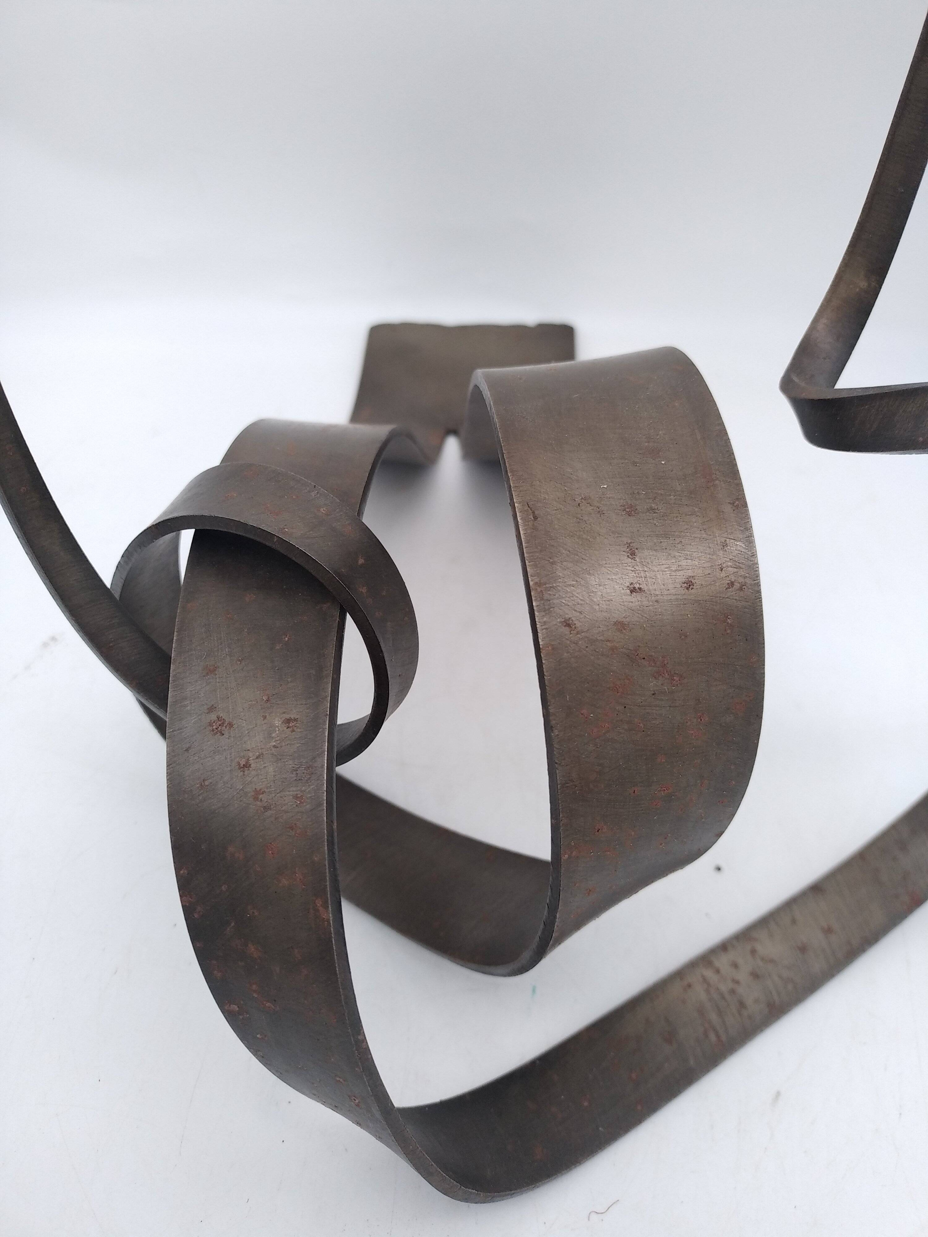 Brutalist candle holder in bronze effect metal.