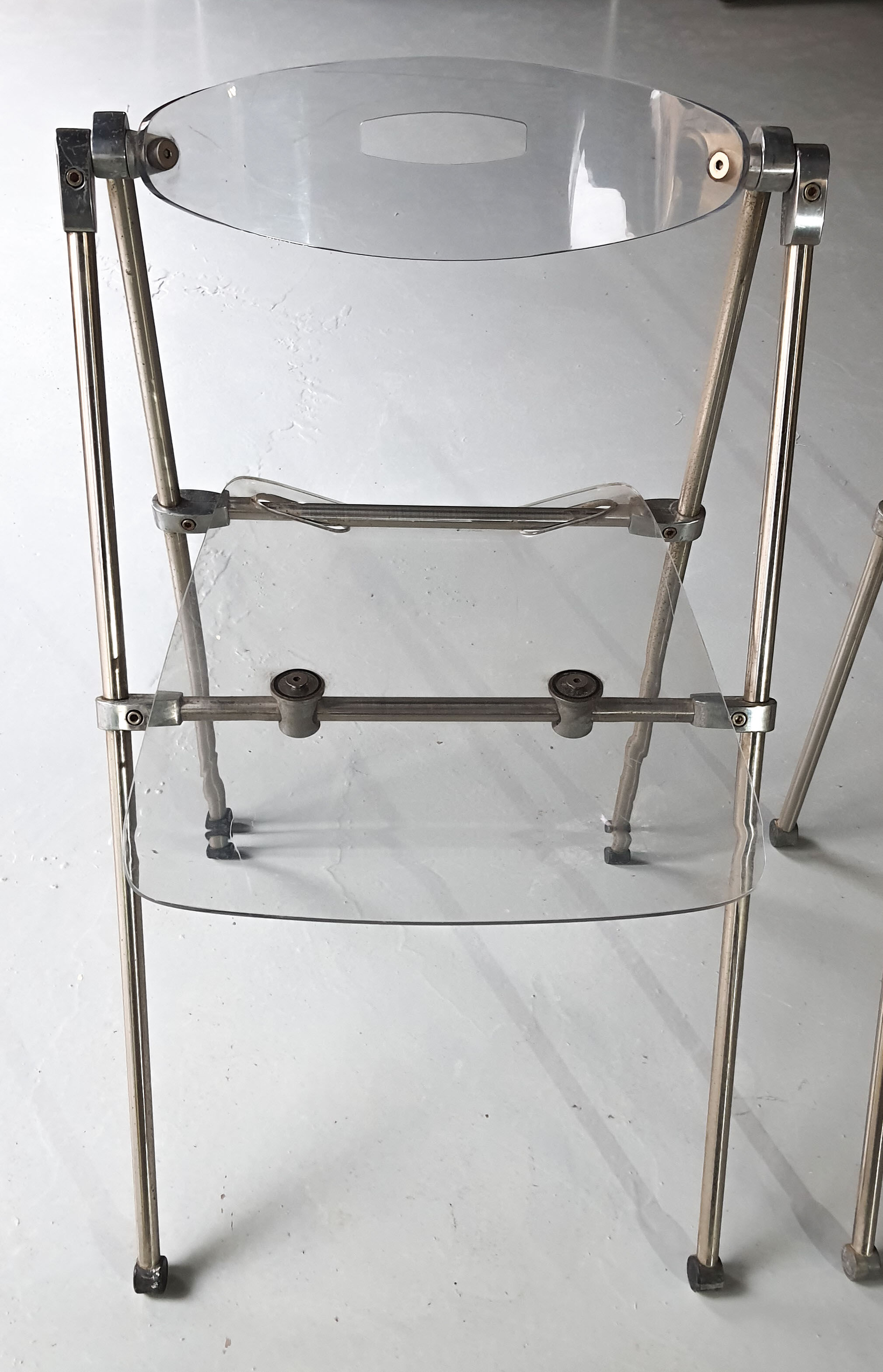 Pair of modern folding chairs in plexiglass