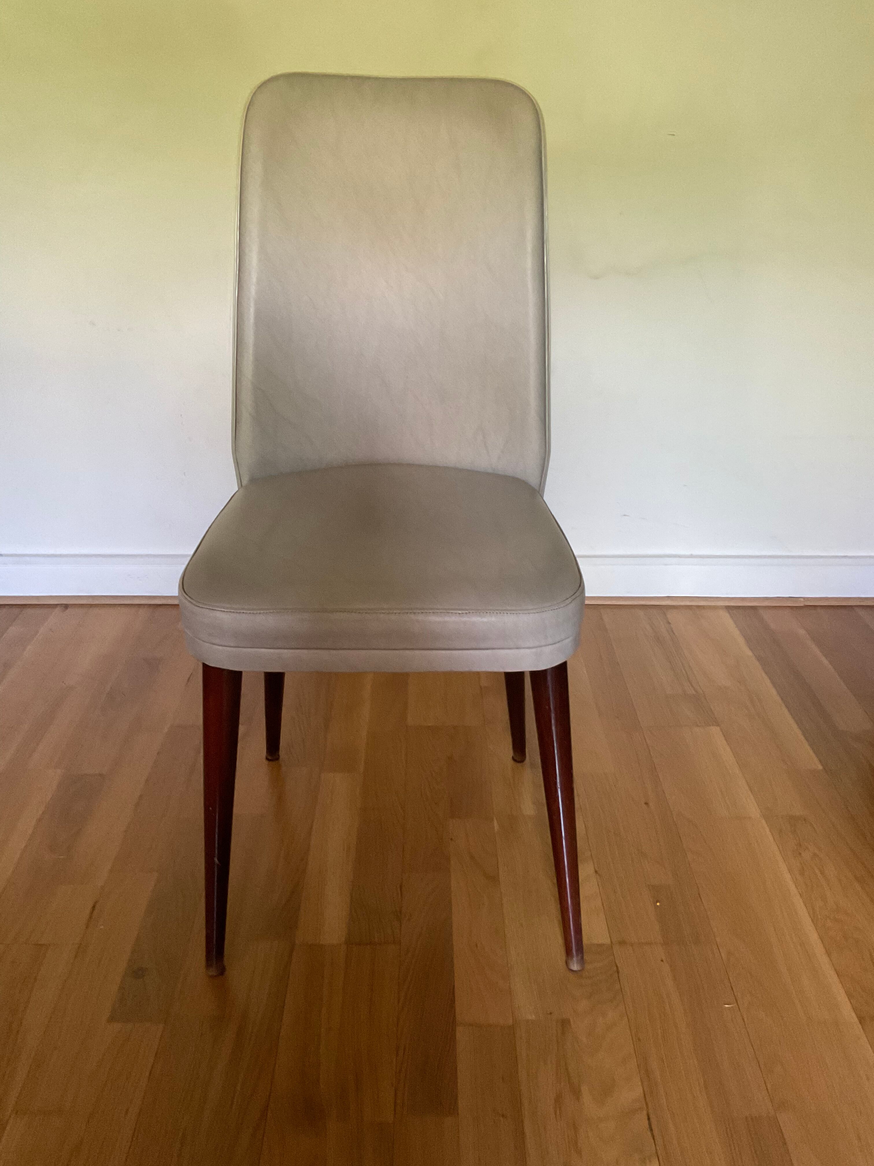 Pair of vintage mahogany and skai chairs