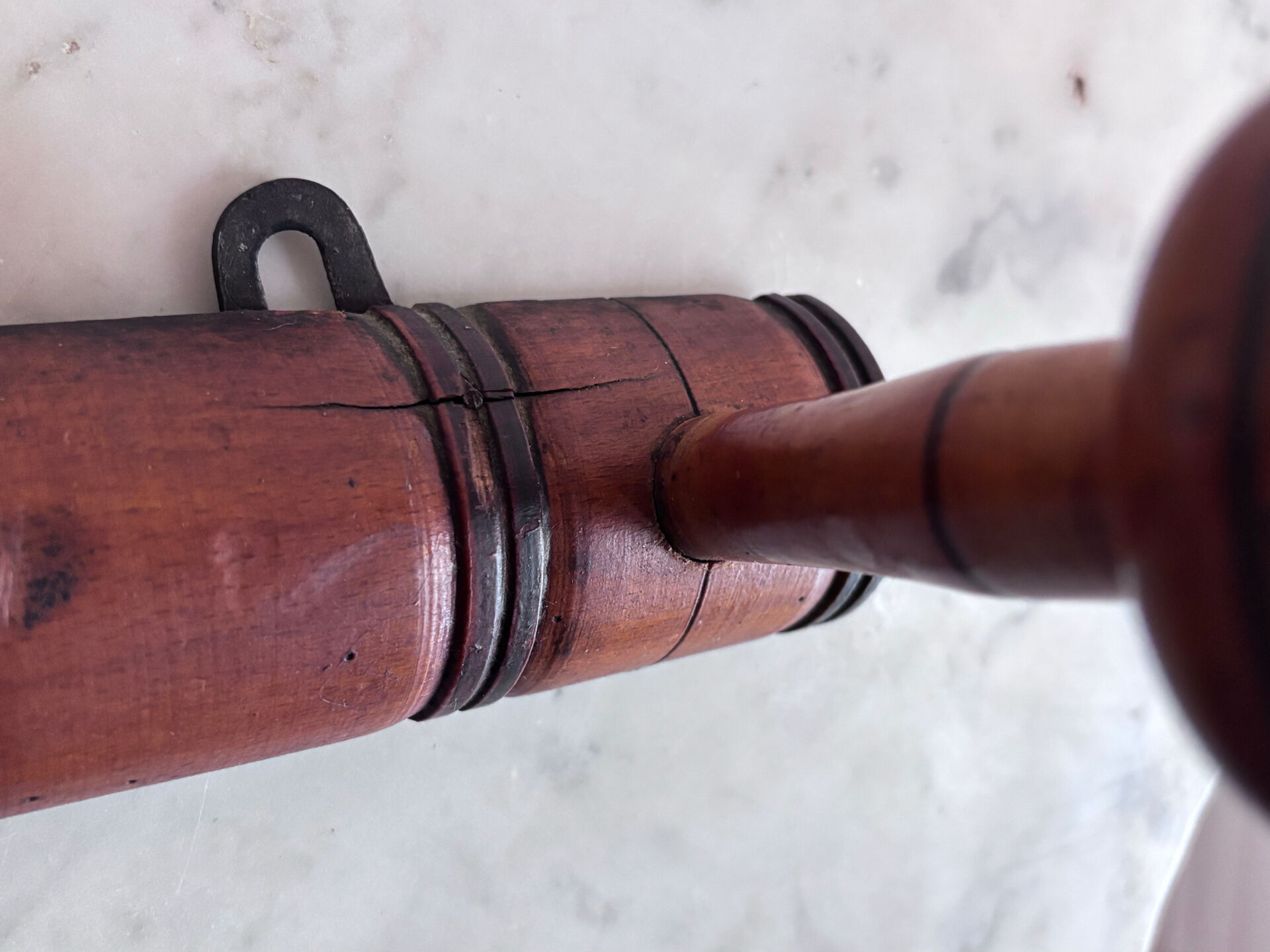 Wall-mounted coat rack with 8 turned wooden hooks in faux bamboo style.