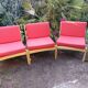 Set of 3 vintage armchairs from the 60s/70s – light wood and red faux leather.