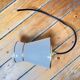 Small white and gold diabolo pendant.