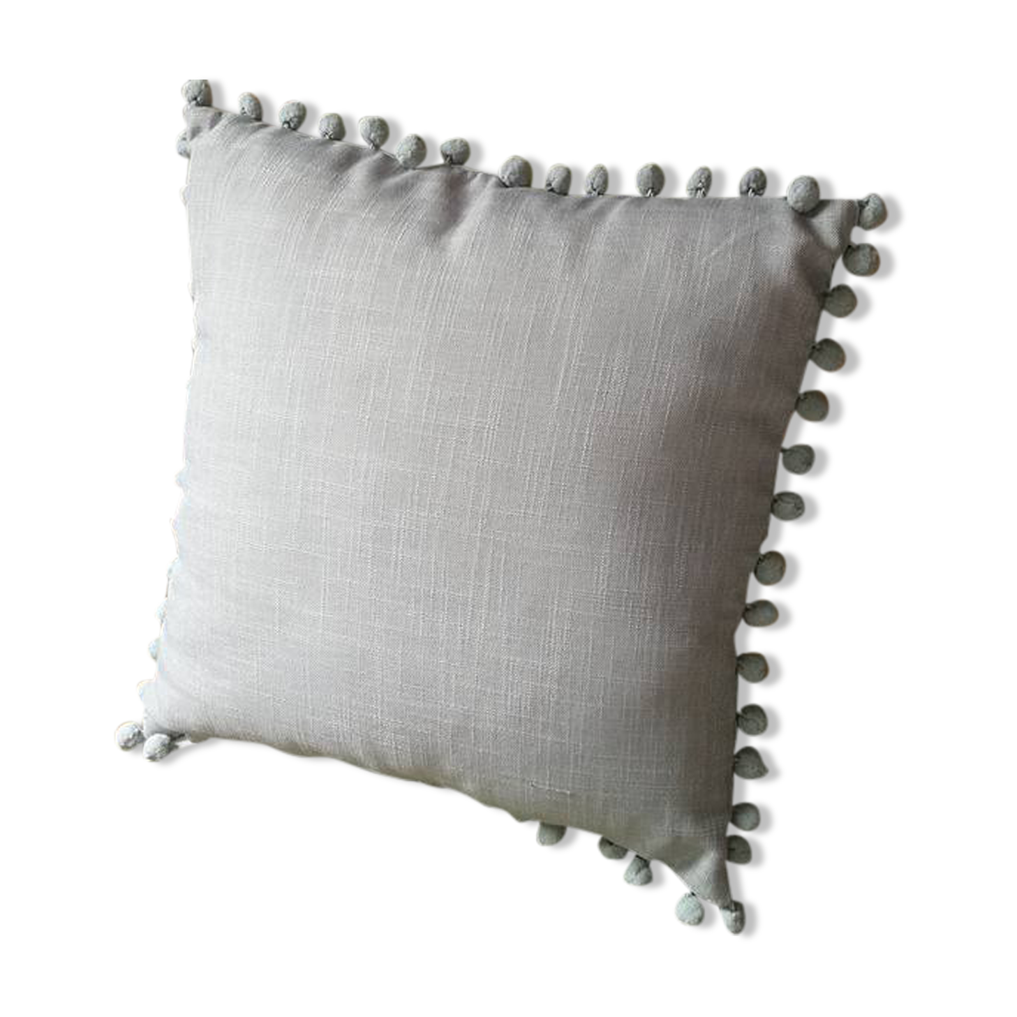 Gray cushion with pompoms