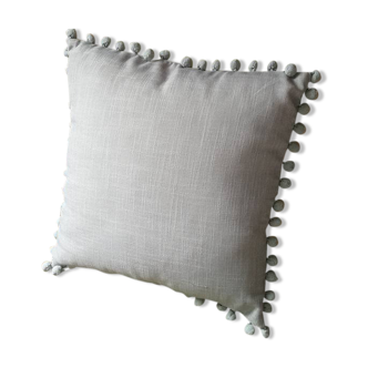 Gray cushion with pompoms