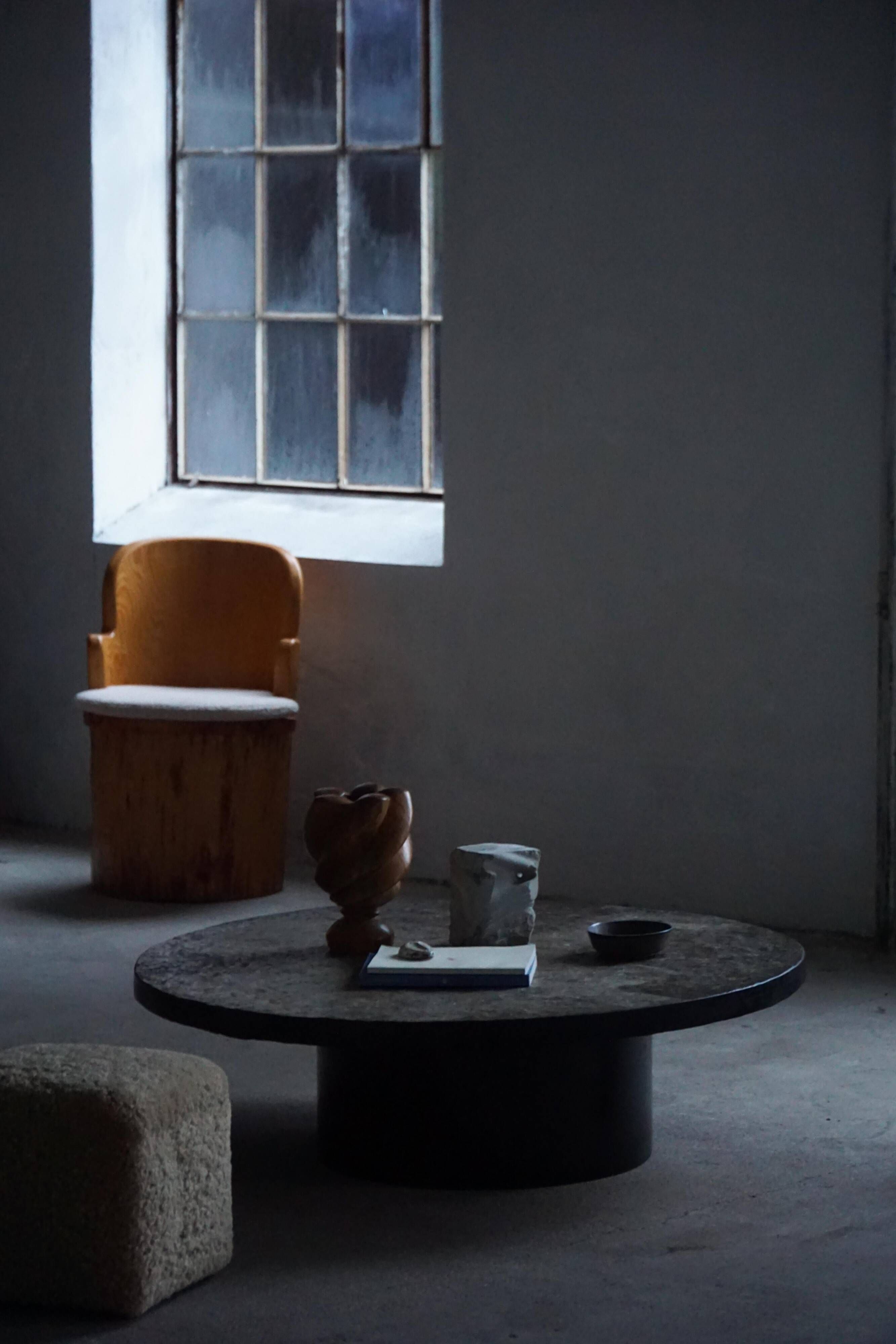 Round brutalist coffee table in stone and steel, mid-century French modernism, 1970s.