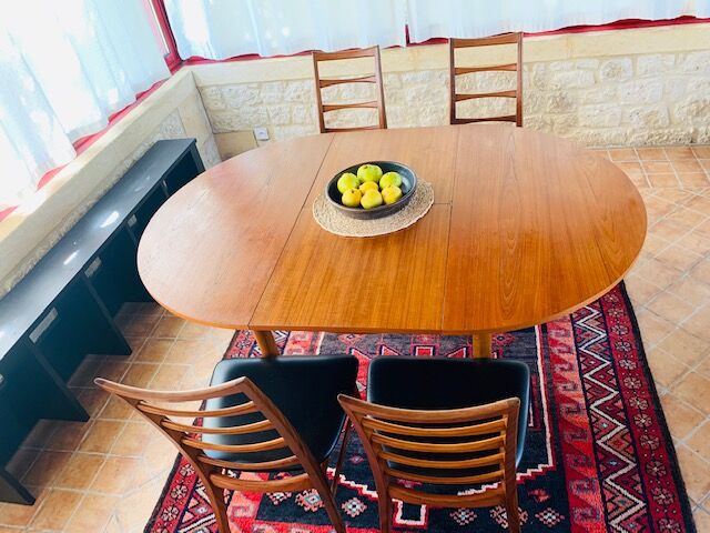 Expandable teak dining table, butterfly extension, circa 60s