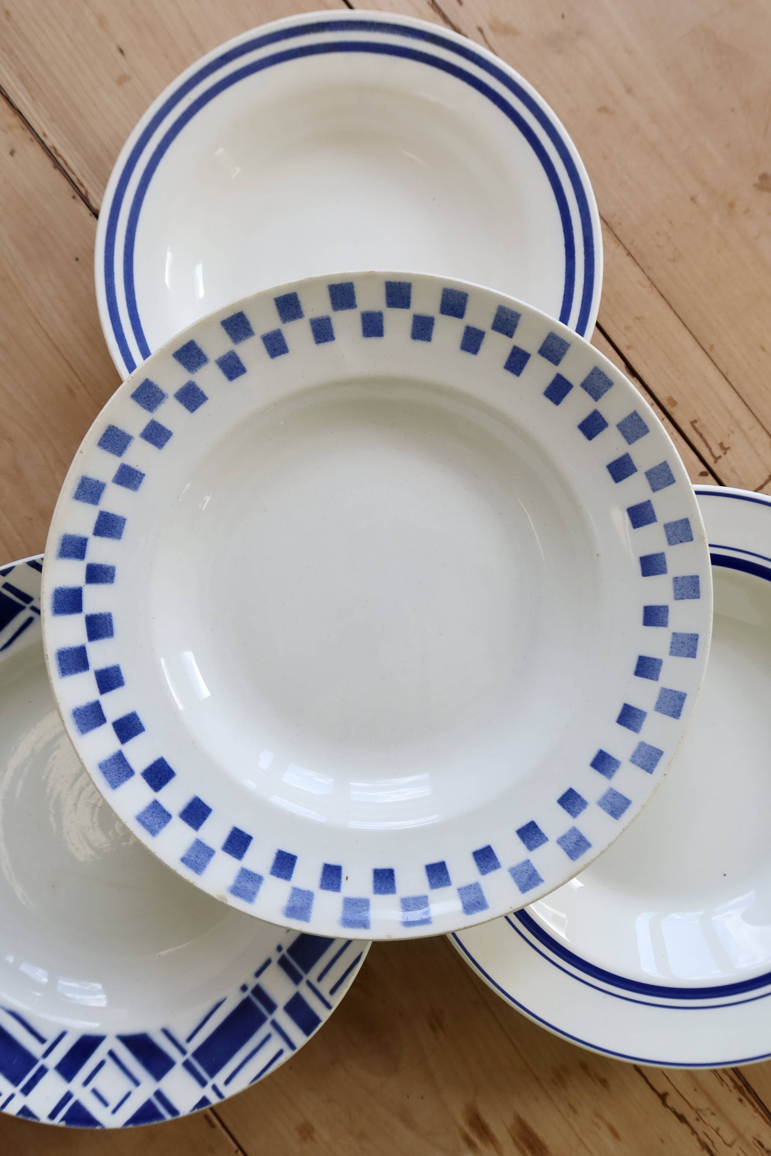 4 mismatched vintage deep plates in blue and white porcelain