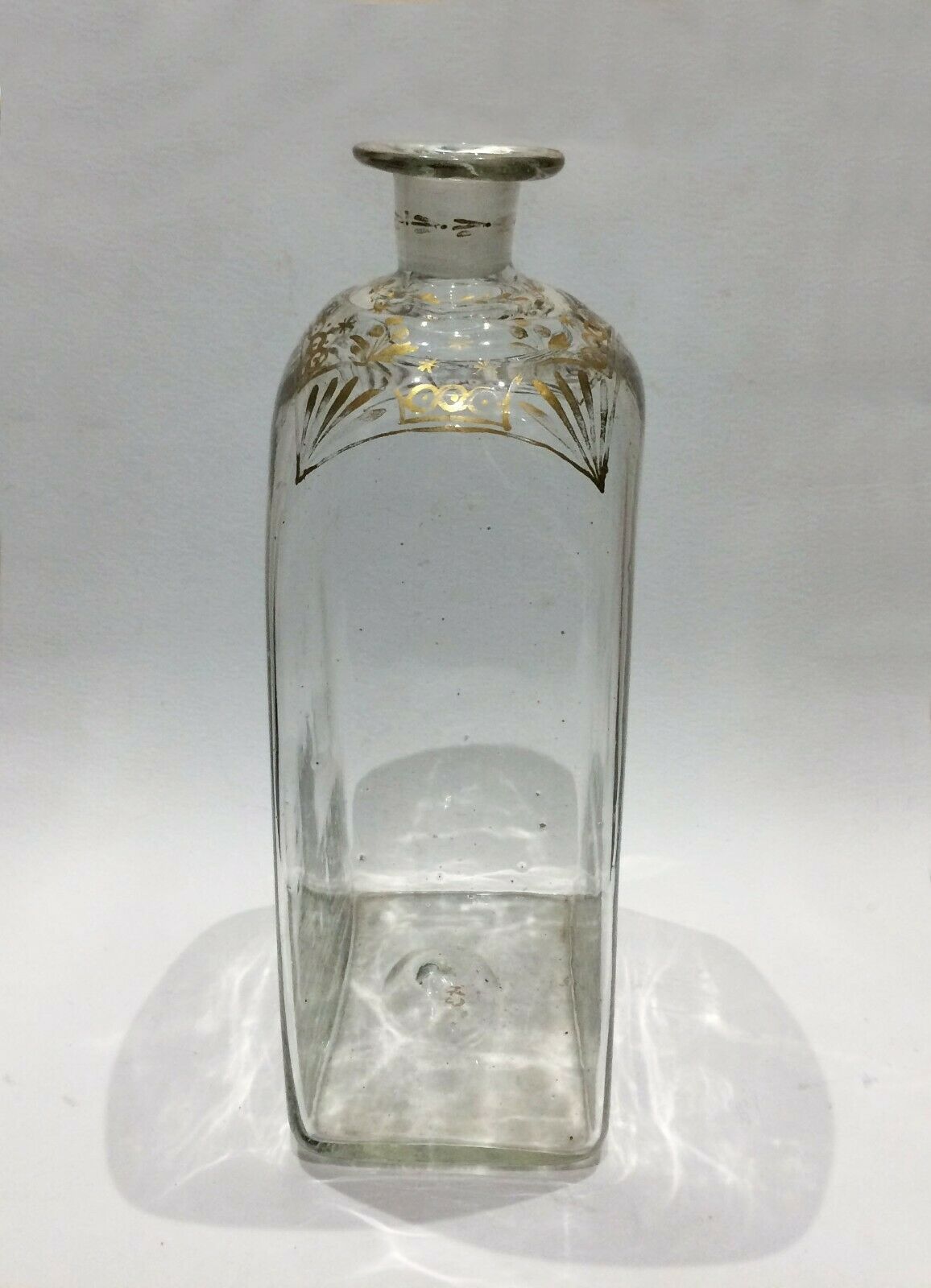 Glass bottle decorated with gold motifs