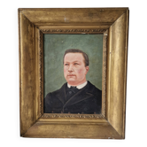 Old portrait of a man in a gilded frame